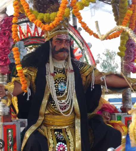 Ravana tableau rides on chariot in Akbarpur, Kanpur countryside, touring the city amidst traditional musical instruments